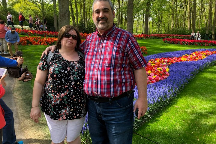 a group of people that are standing in the grass