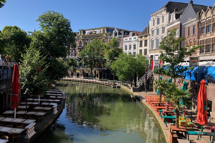 a small boat in a body of water with a city in the background