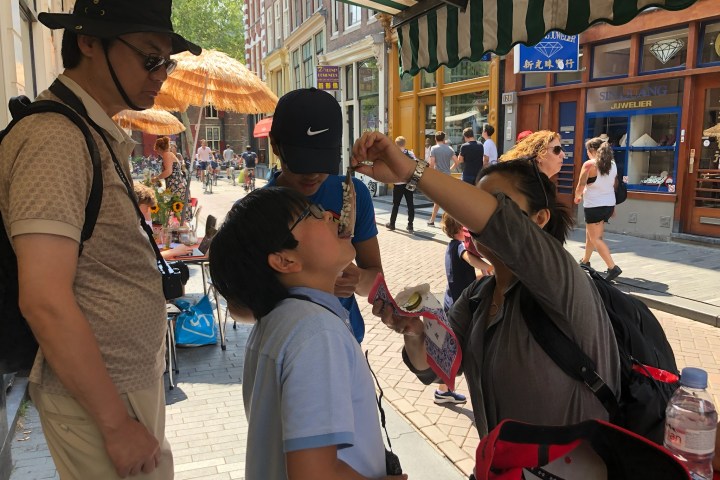 a group of people looking at a cell phone