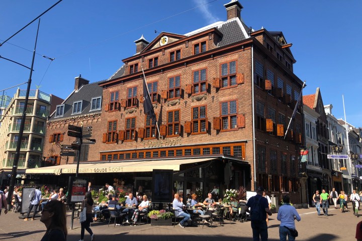 a group of people walking in front of a building