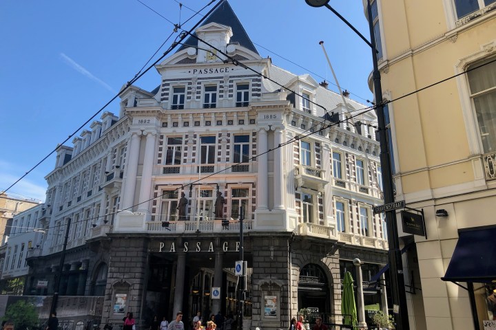 a group of people walking in front of a building