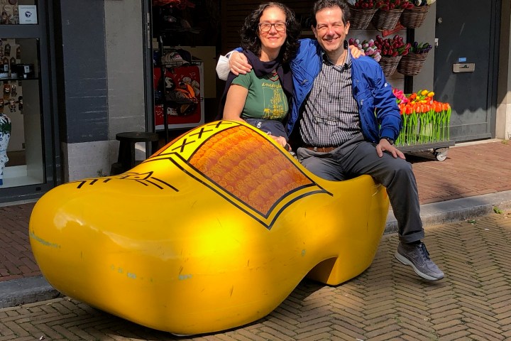 a man and a woman sitting on a sidewalk