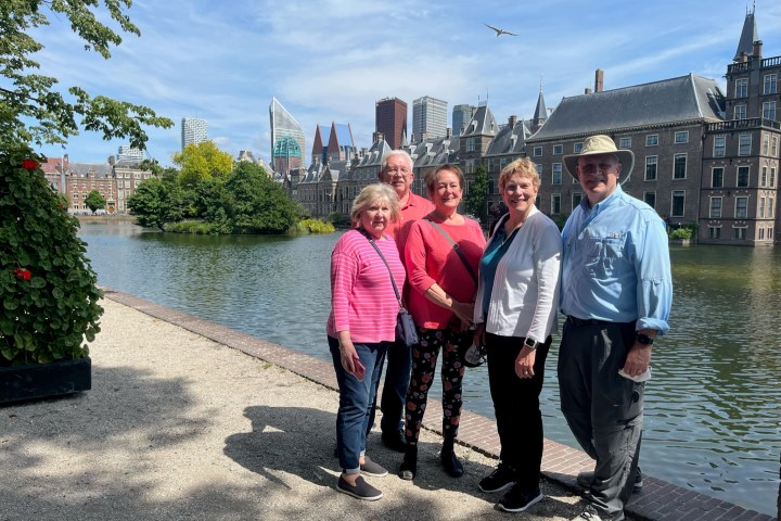 a group of people standing in front of a body of water