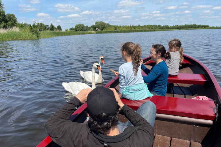 a person sitting in a boat on a body of water