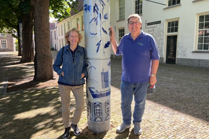 a man and a woman standing in front of a building