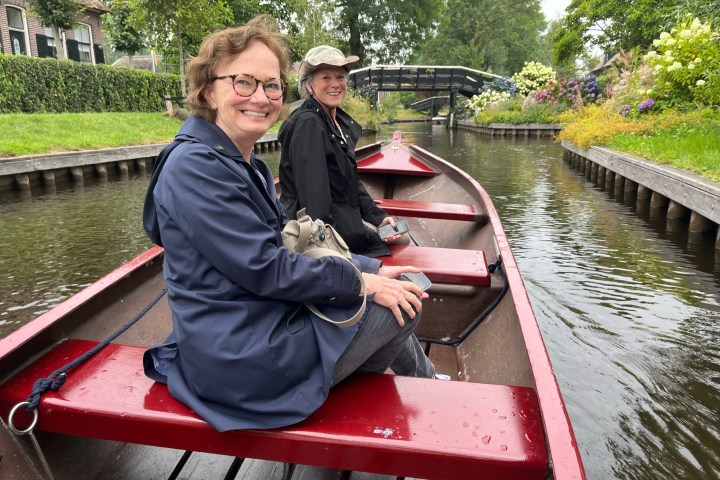 a person sitting in a boat on a river