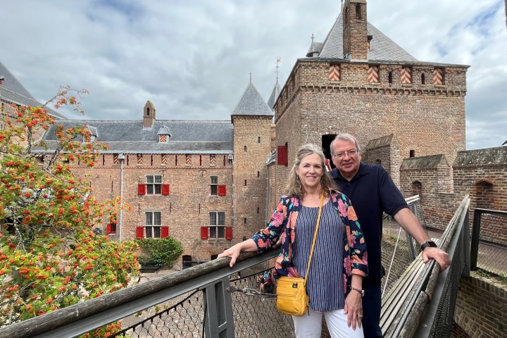 a man and a woman standing in front of a building