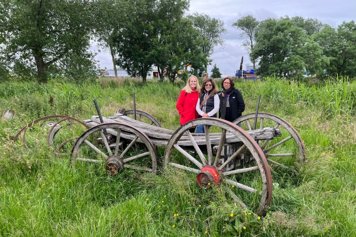 a group of people standing in front of a bicycle