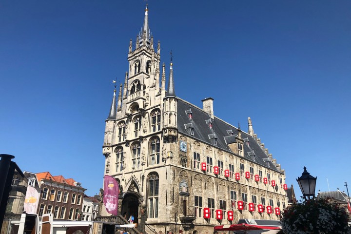 a group of people walking in front of a large building