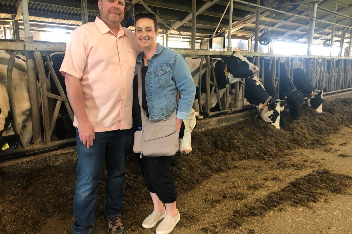 a man standing next to a building