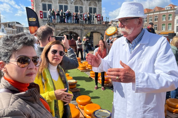 a group of people holding glasses of beer
