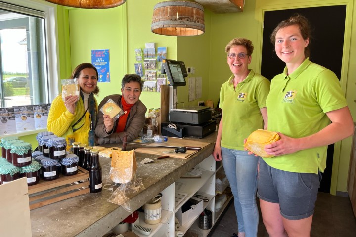 a group of people standing around a table