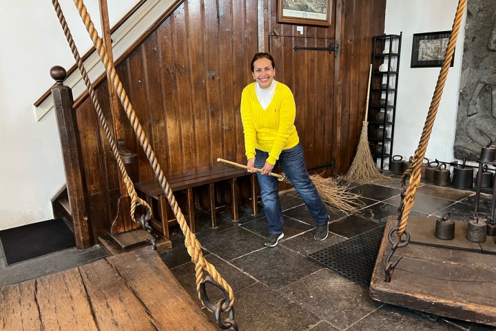 a man standing next to a fence