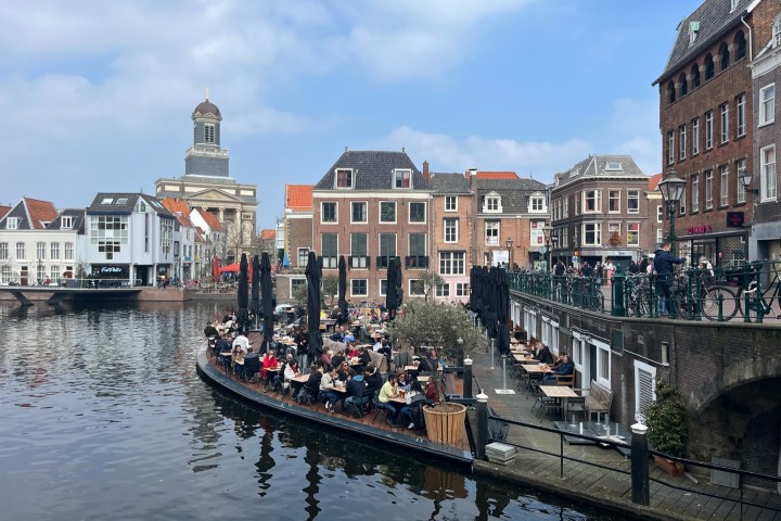 a boat in the water with a city in the background