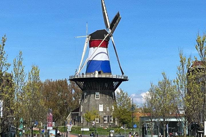 a small clock tower in the middle of a road