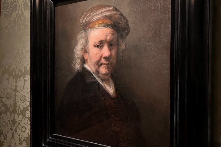 a man standing in front of a mirror posing for the camera
