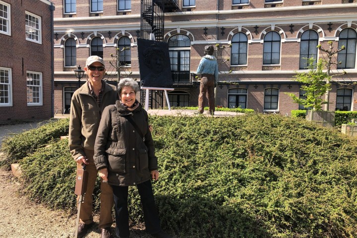 a man and a woman standing in front of a building