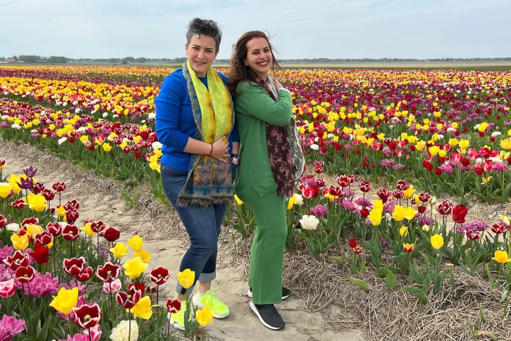 Toni Halliday standing in front of a flower