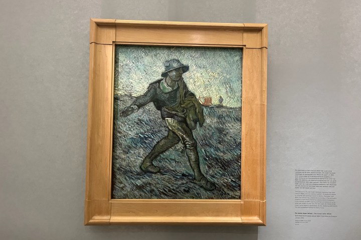 Framed painting of a person sowing seeds in a field.