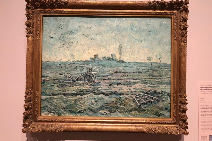 Framed Van Gogh painting of a snowy field with scattered harrows.
